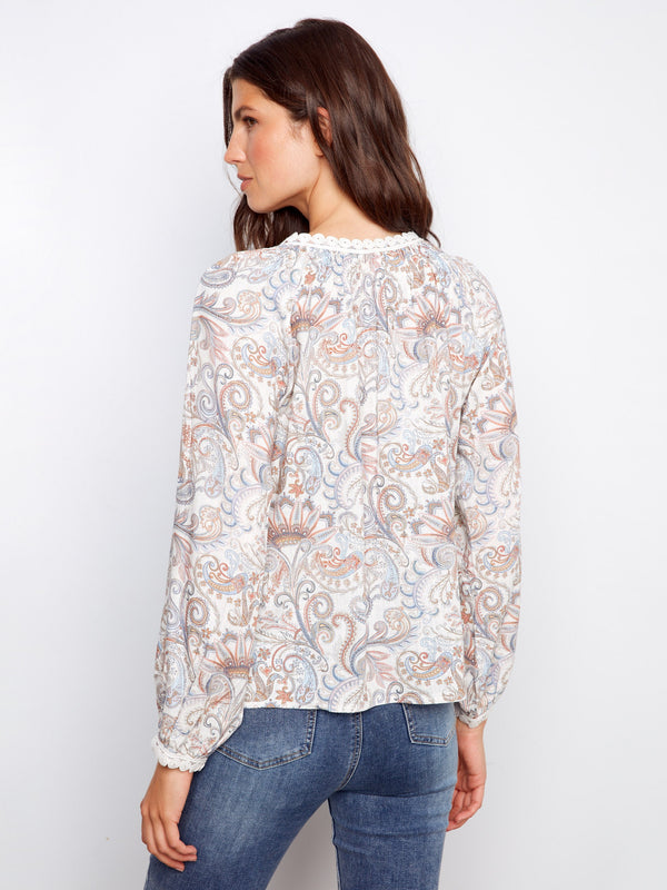 Blouse featuring an exquisite paisley motif and crochet details at cuffs, offering a refined look with raglan sleeves by Charlie B.