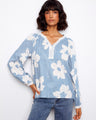 Floral blouse with a crochet trim neckline, featuring raglan sleeves and delicate detailing, perfect for casual elegance by Charlie B.
