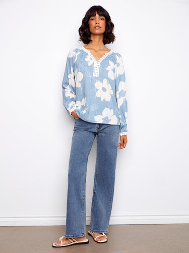 Elegant blouse adorned with crochet trim cuffs and raglan sleeves, creating a relaxed yet sophisticated style by Charlie B.