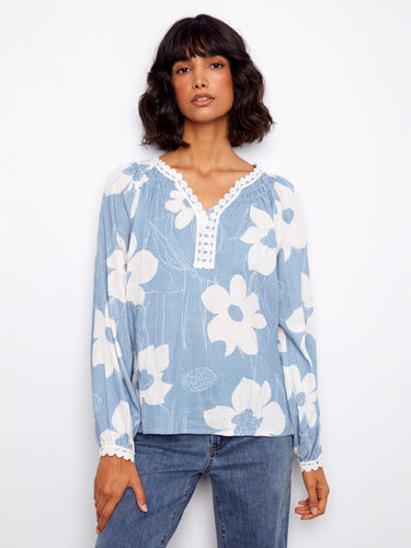 Floral print top accentuated with crochet trim detailing at the neckline and cuffs. Designed by Charlie B.