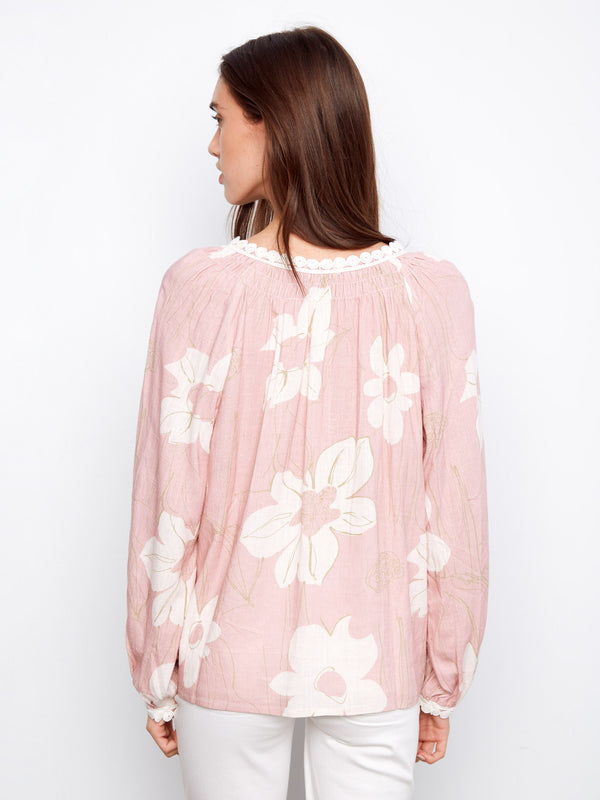 Beautiful floral design on this blouse, enhanced by its unique notch neckline and comfortable fit. By Charlie B.