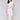White pants with a smocked waistband and floral border print by Charlie B.
