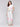 White pants with a smocked waistband and floral border print by Charlie B.