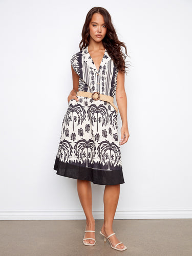 Black and white printed dress with a tailored neckline and straw belt, featuring cap sleeves and knee-length design by Charlie B.