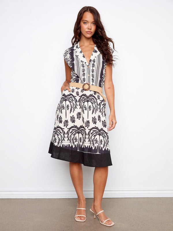 Black and white printed dress with a tailored neckline and straw belt, featuring cap sleeves and knee-length design by Charlie B.