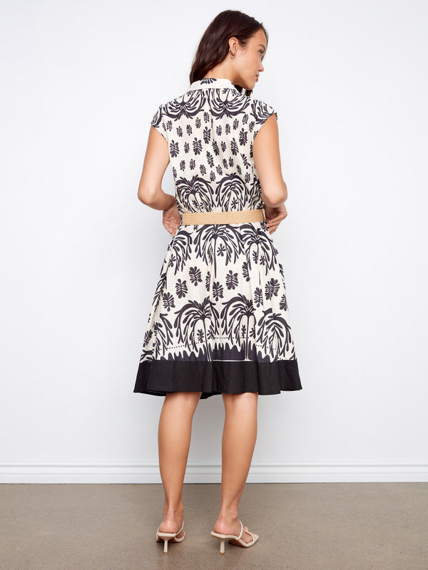 Chic linen-cotton dress in black and white print featuring knee-length cut, tailored neckline, and straw belt by Charlie B.