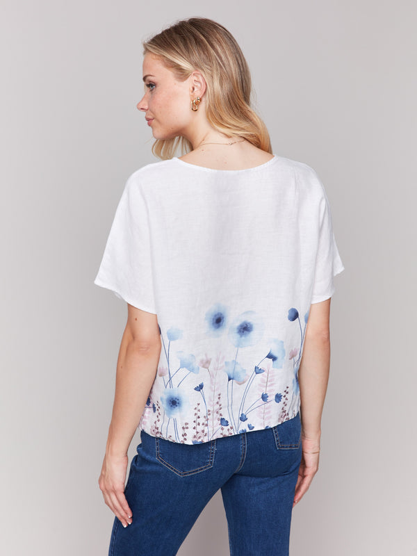Crafted from 100% linen, this floral border top is perfect for warm days by Charlie B.