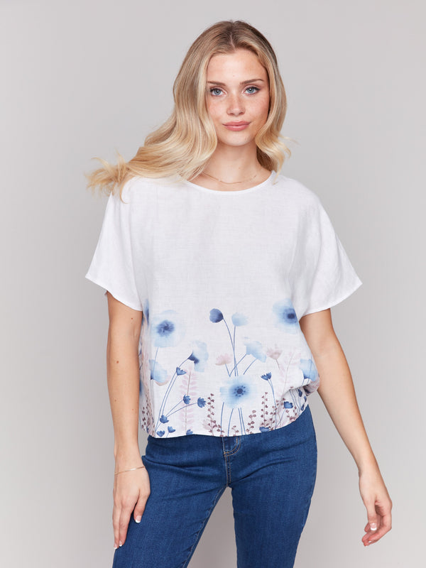 Floral border print enhances this stylish short-sleeve linen top by Charlie B.