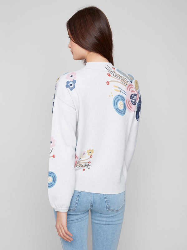Heather light grey sweater featuring colorful floral prints and a classic mock neck design by Charlie B.