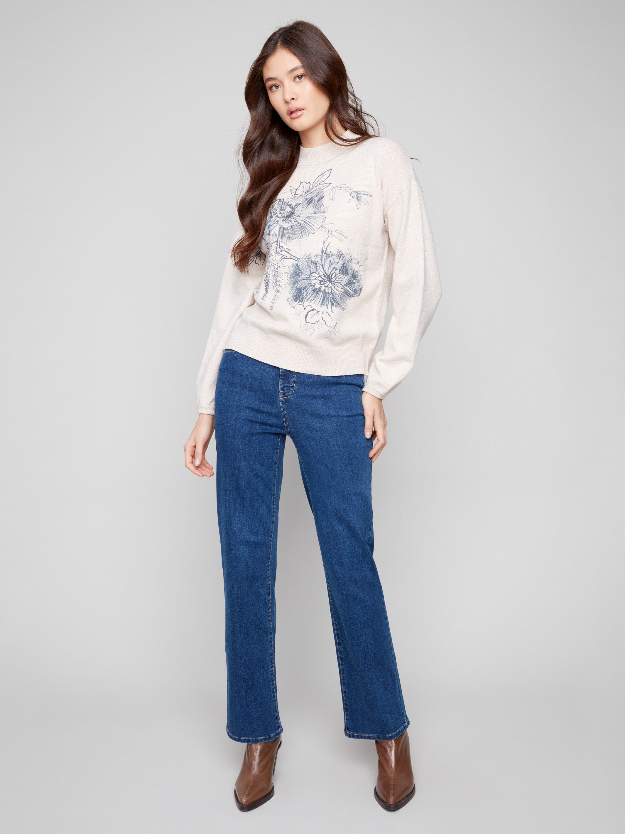 Elegant oat sweater showcasing floral design with elastic cuffs and stylish mock neck by Charlie B.