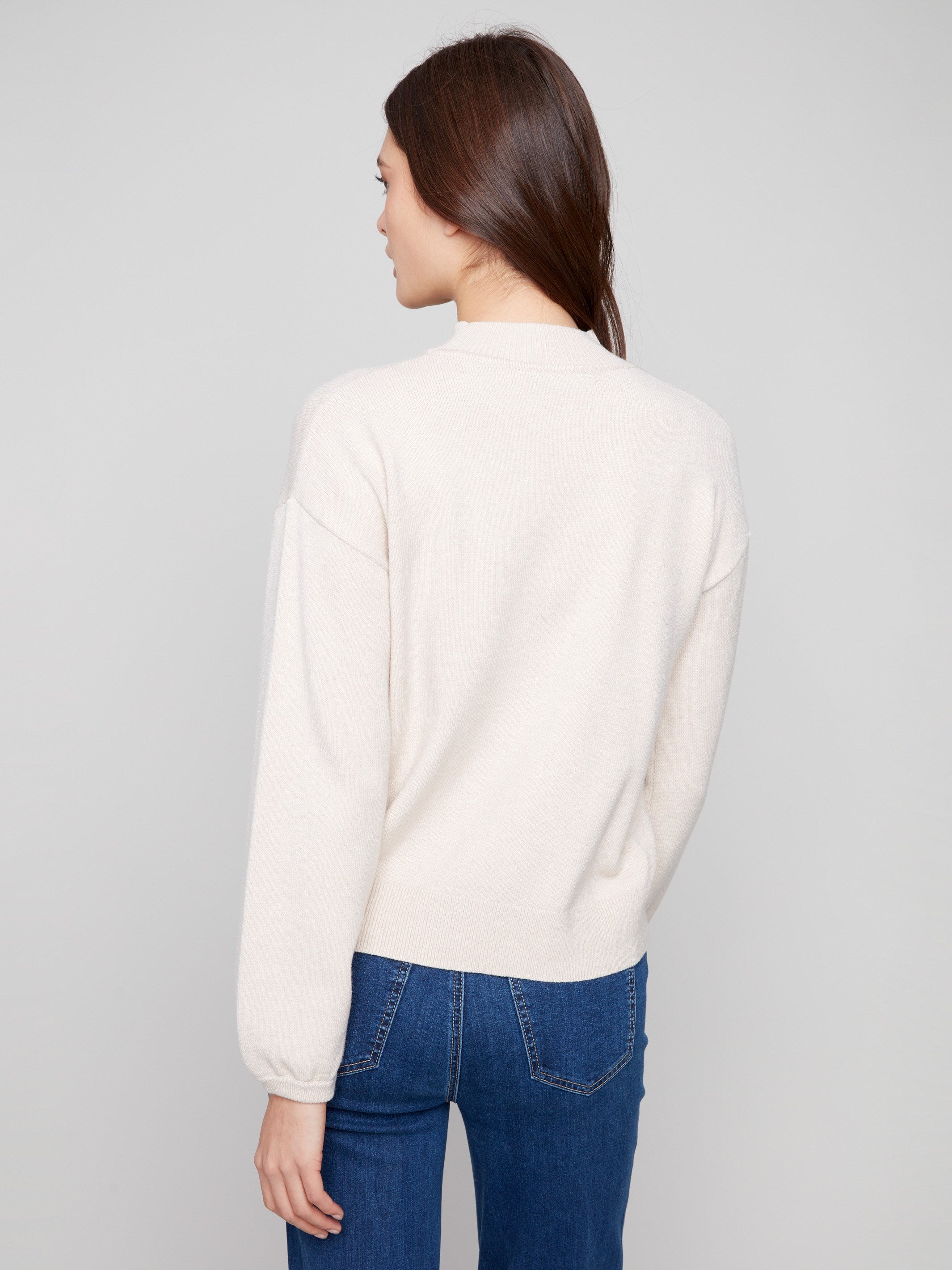 Chic heather oat sweater adorned with floral motifs, complete with elastic cuffs for added comfort by Charlie B.