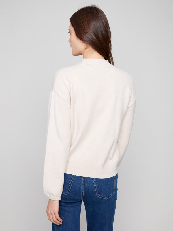 Chic heather oat sweater adorned with floral motifs, complete with elastic cuffs for added comfort by Charlie B.