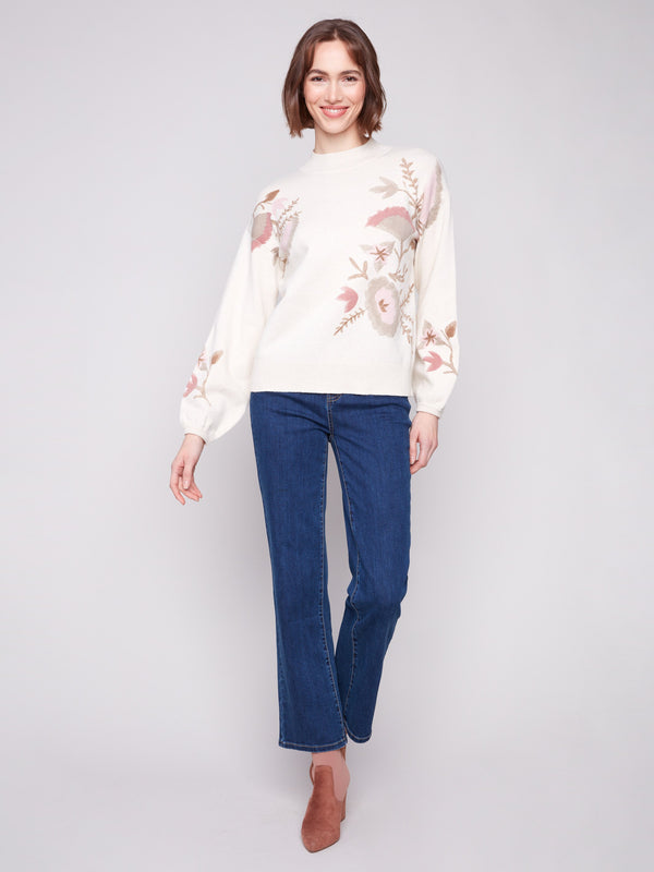 Stylish sweater featuring elastic cuffs and a beautiful floral design for added flair by Charlie B.