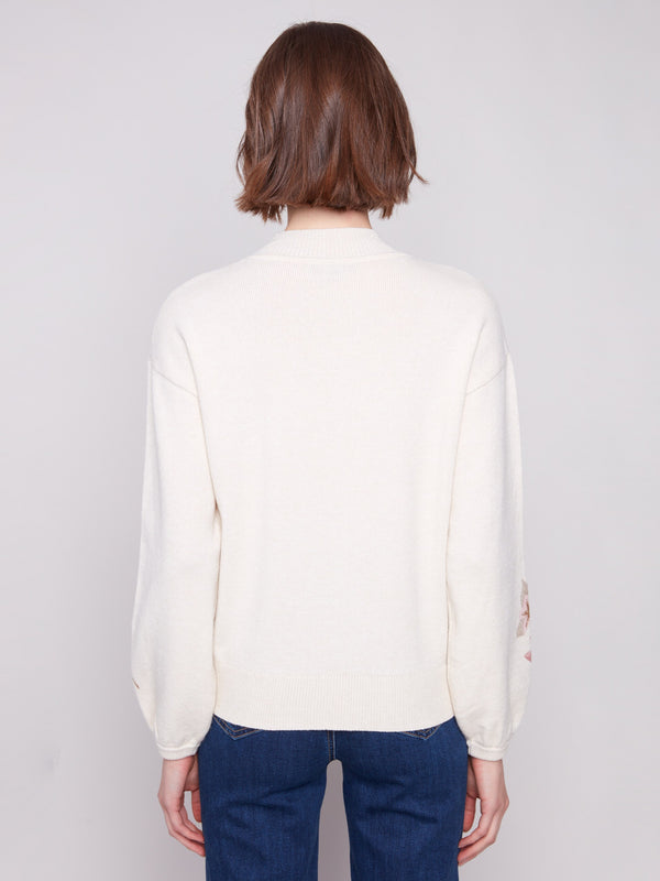 Heather natural sweater designed with elastic cuffs and a delightful floral pattern by Charlie B.