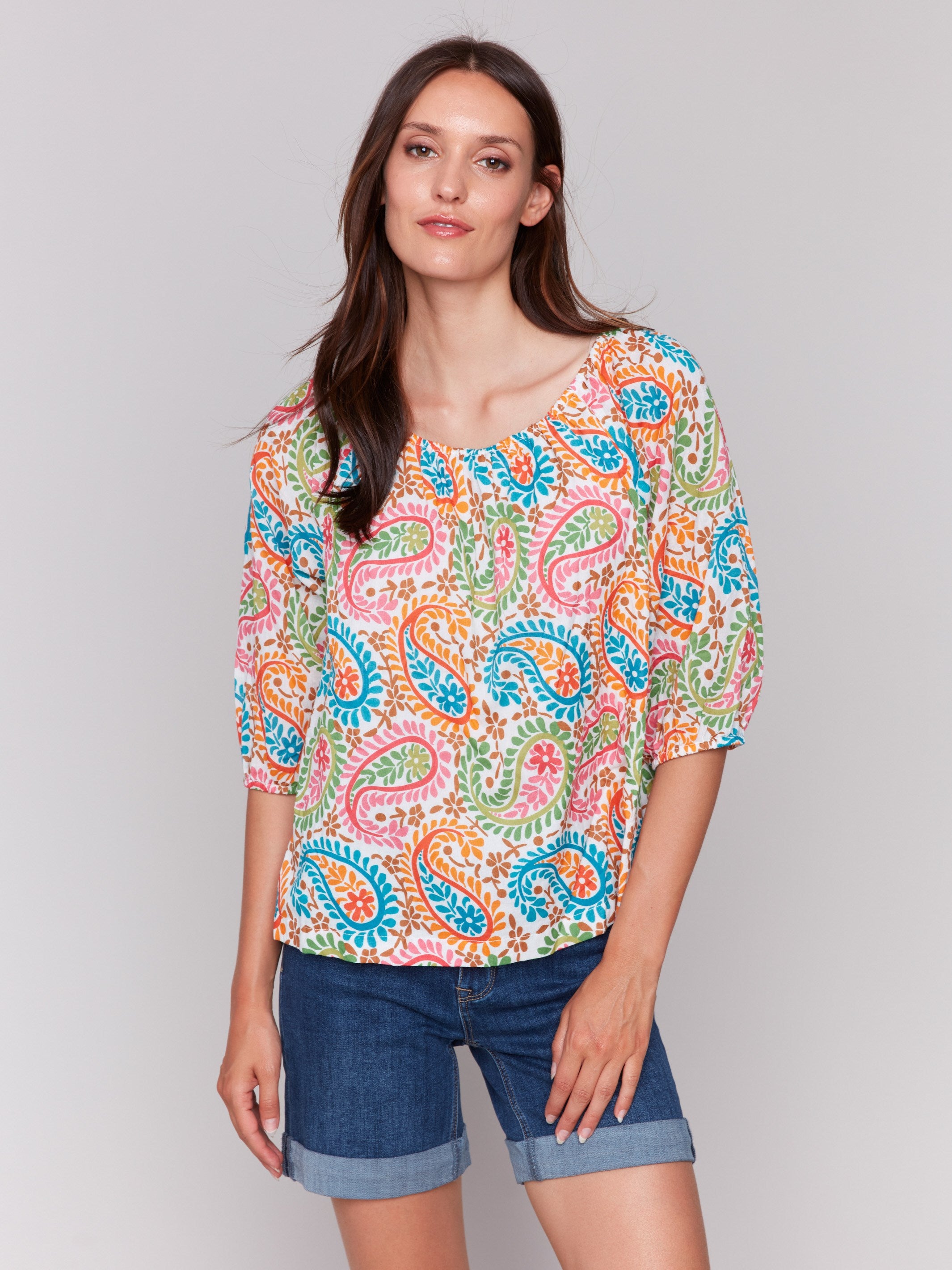 Elegant 3/4 sleeve blouse featuring a colorful pattern by Charlie B.