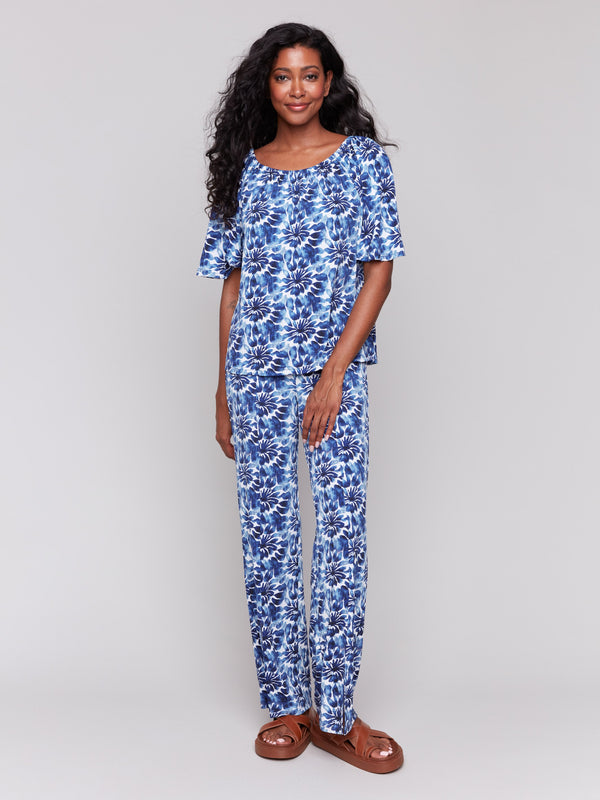 Elegant off-the-shoulder style with floral motifs by Charlie B.