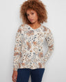 Floral print sweater with a V-neck and long sleeves, featuring side slits for added style by Charlie B.