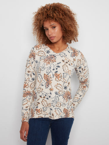Floral print sweater with a V-neck and long sleeves, featuring side slits for added style by Charlie B.