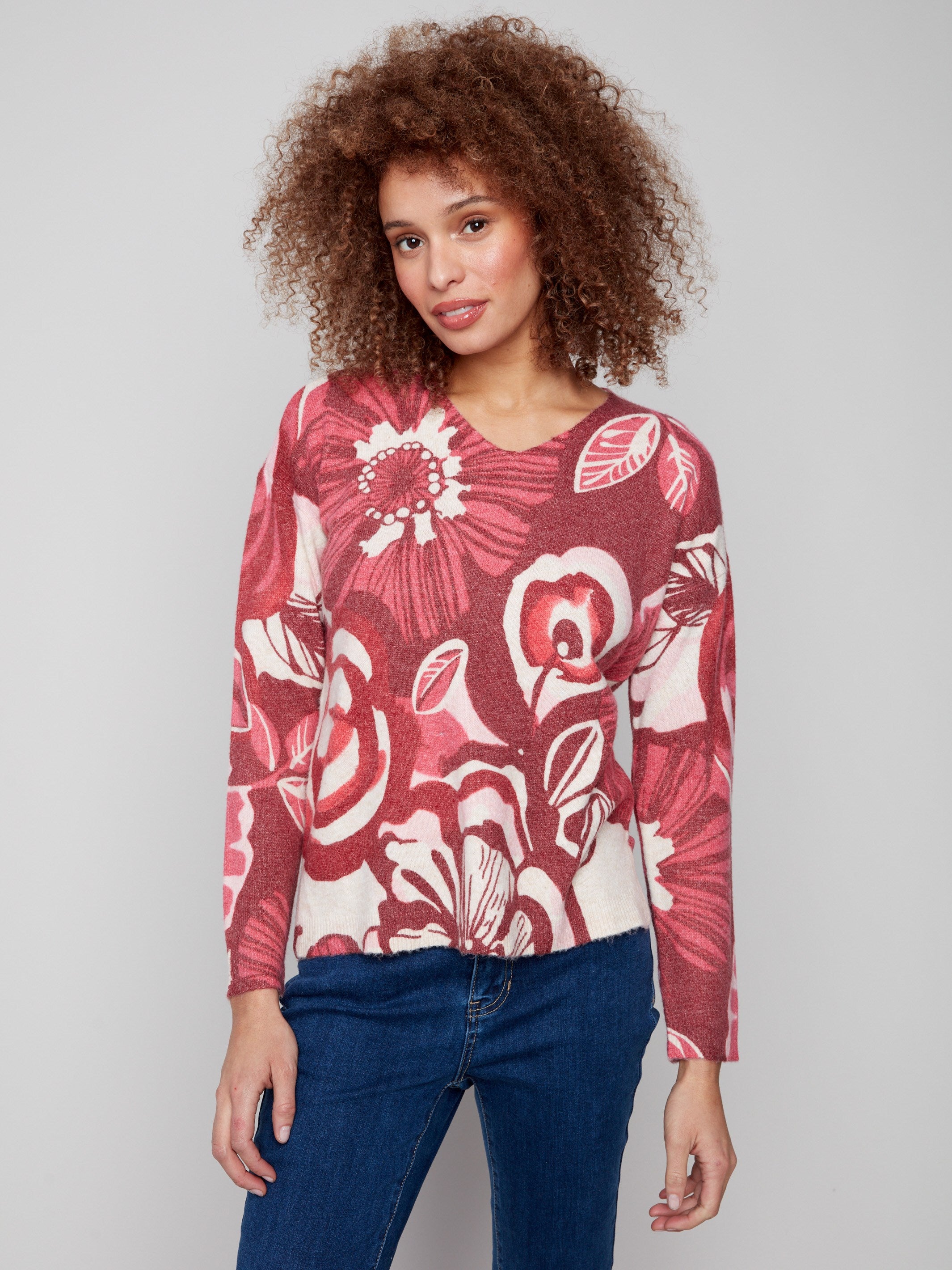 Floral sweater featuring plush texture and vibrant red and pink hues, perfect for cozy days by Charlie B.