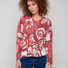 Floral sweater featuring plush texture and vibrant red and pink hues, perfect for cozy days by Charlie B.