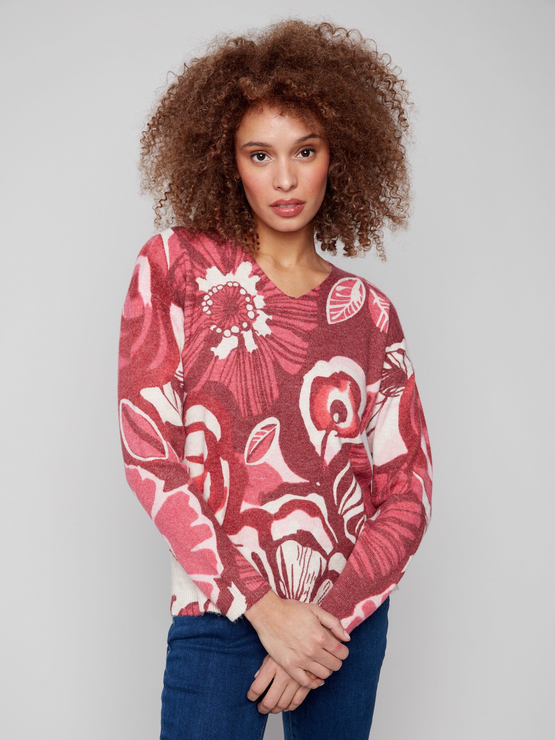 Sweater with drop shoulders and vivid floral pattern, offering comfort and style by Charlie B.