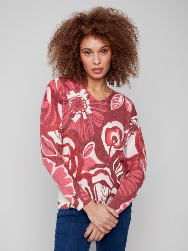 Sweater with drop shoulders and vivid floral pattern, offering comfort and style by Charlie B.