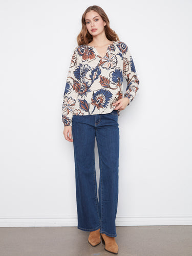 Charming floral print blouse designed with a notch neckline, perfect for casual elegance by Charlie B.