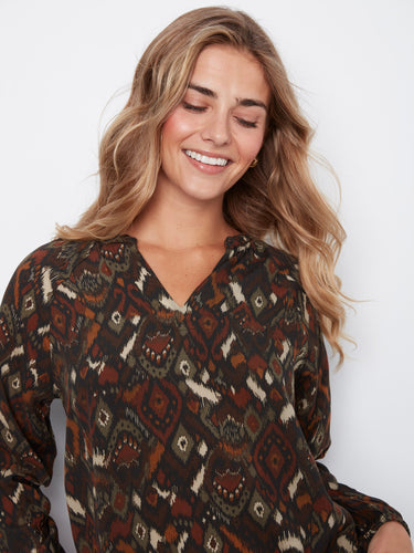 Crafted from soft viscose fabric, this blouse offers a luxurious feel against the skin while maintaining its chic appearance. By Charlie B.