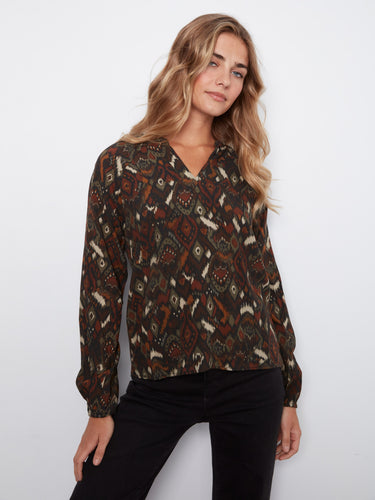 A must-have addition to your wardrobe, this blouse pairs well with various styles, offering endless outfit possibilities by Charlie B.