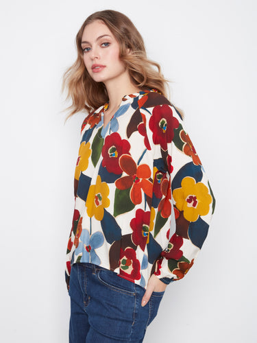 Experience the luxury of soft viscose fabric with this colorful floral blouse, offering both comfort and style by Charlie B.