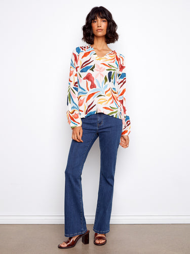 Stylish blouse featuring braided collar detail and colorful design, ideal for casual or formal occasions by Charlie B.