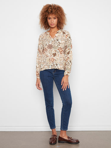 Elegant blouse with raglan sleeves offering a chic look and comfortable fit. Made from soft viscose fabric by Charlie B.