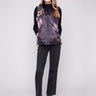 Quilted vest featuring a zipper front closure, ideal for layering and adding style to any outfit by Charlie B.