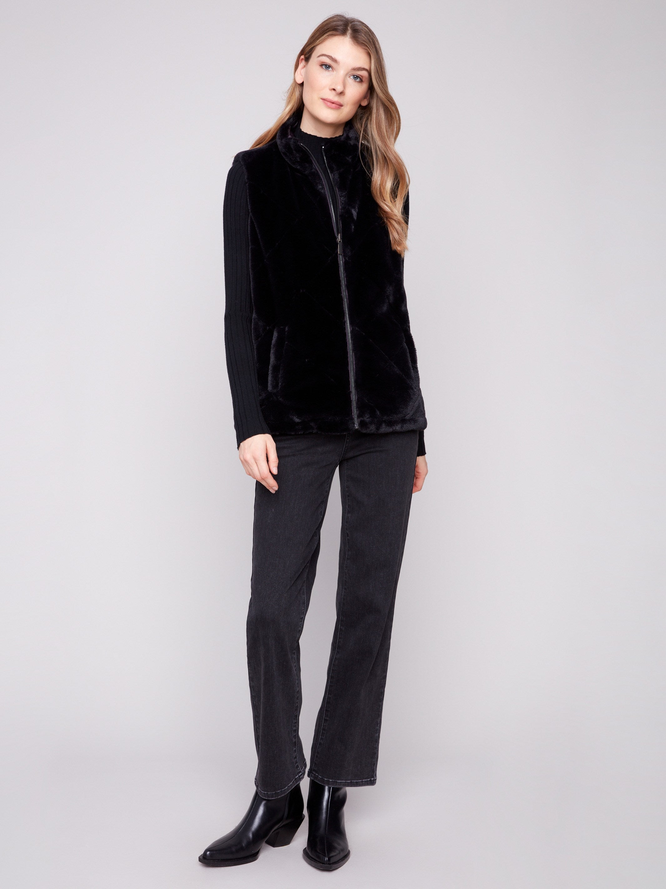 Plush black faux fur vest with welt pockets, offering both warmth and functionality by Charlie B.