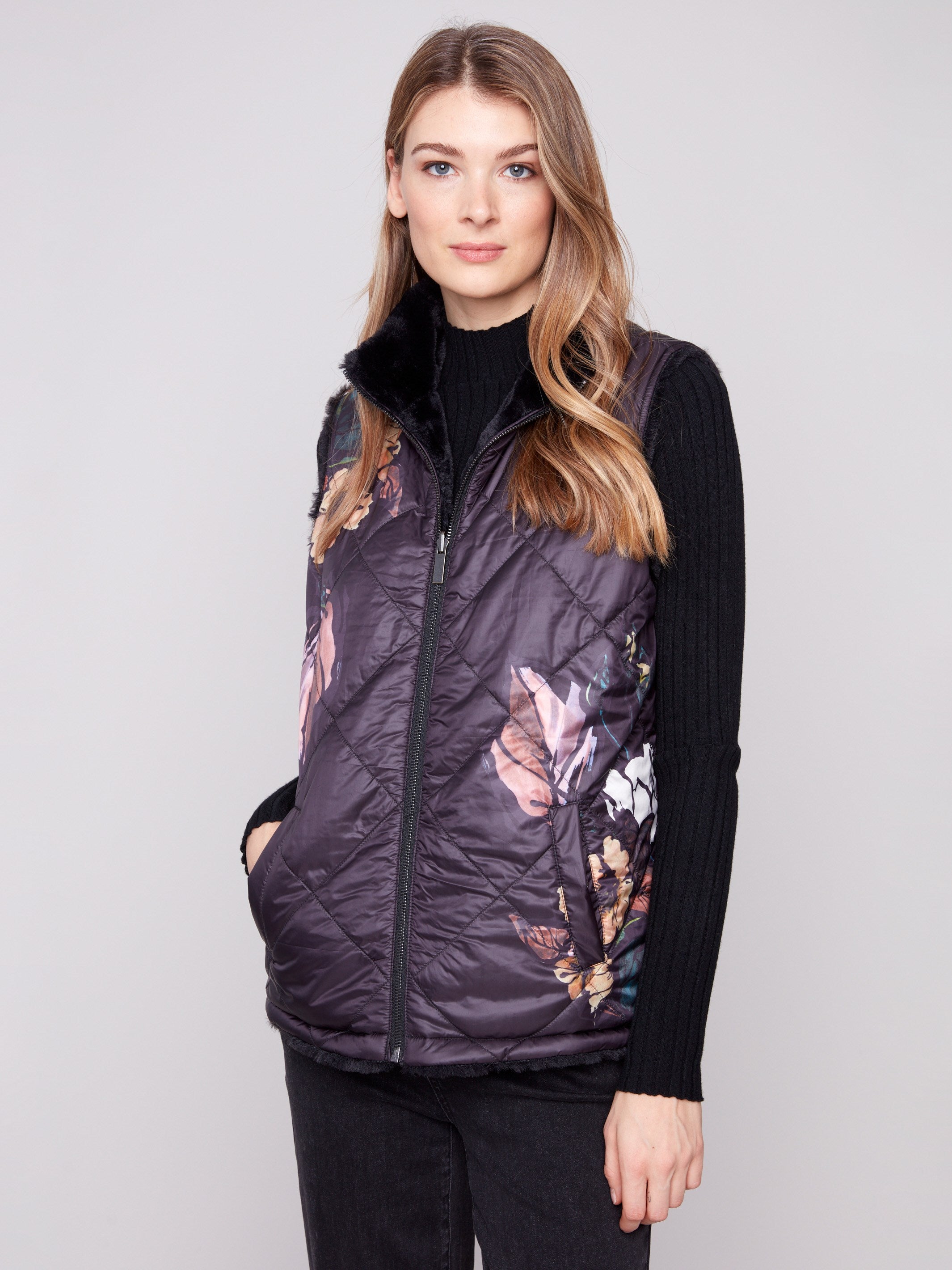 Floral print quilted vest with welt pockets for convenient storage on the go by Charlie B.
