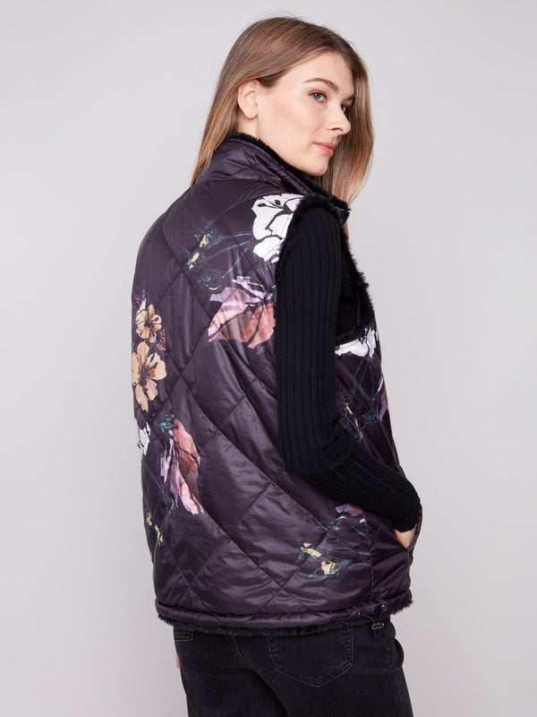 Elegant floral quilted pattern combined with plush comfort in this versatile reversible vest by Charlie B.
