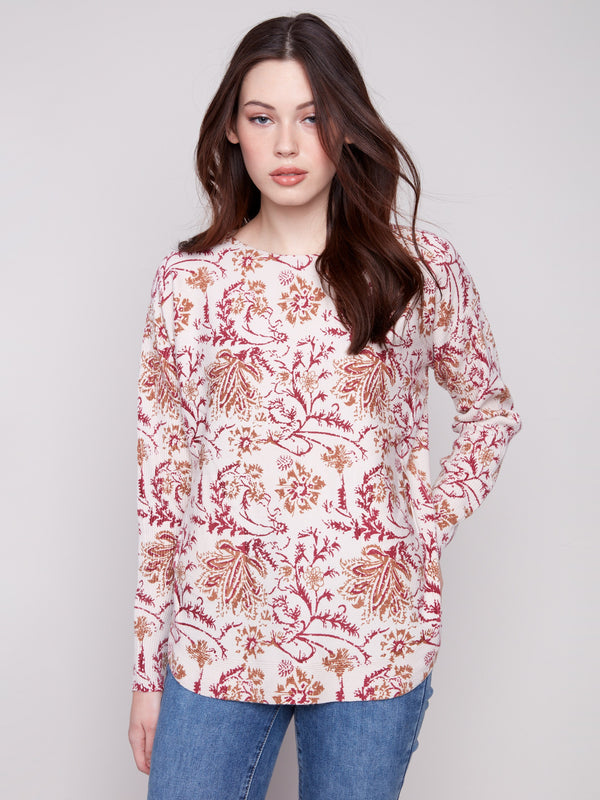 Sweater featuring an abstract floral design with a boat neck, offering a stylish and comfortable look by Charlie B.