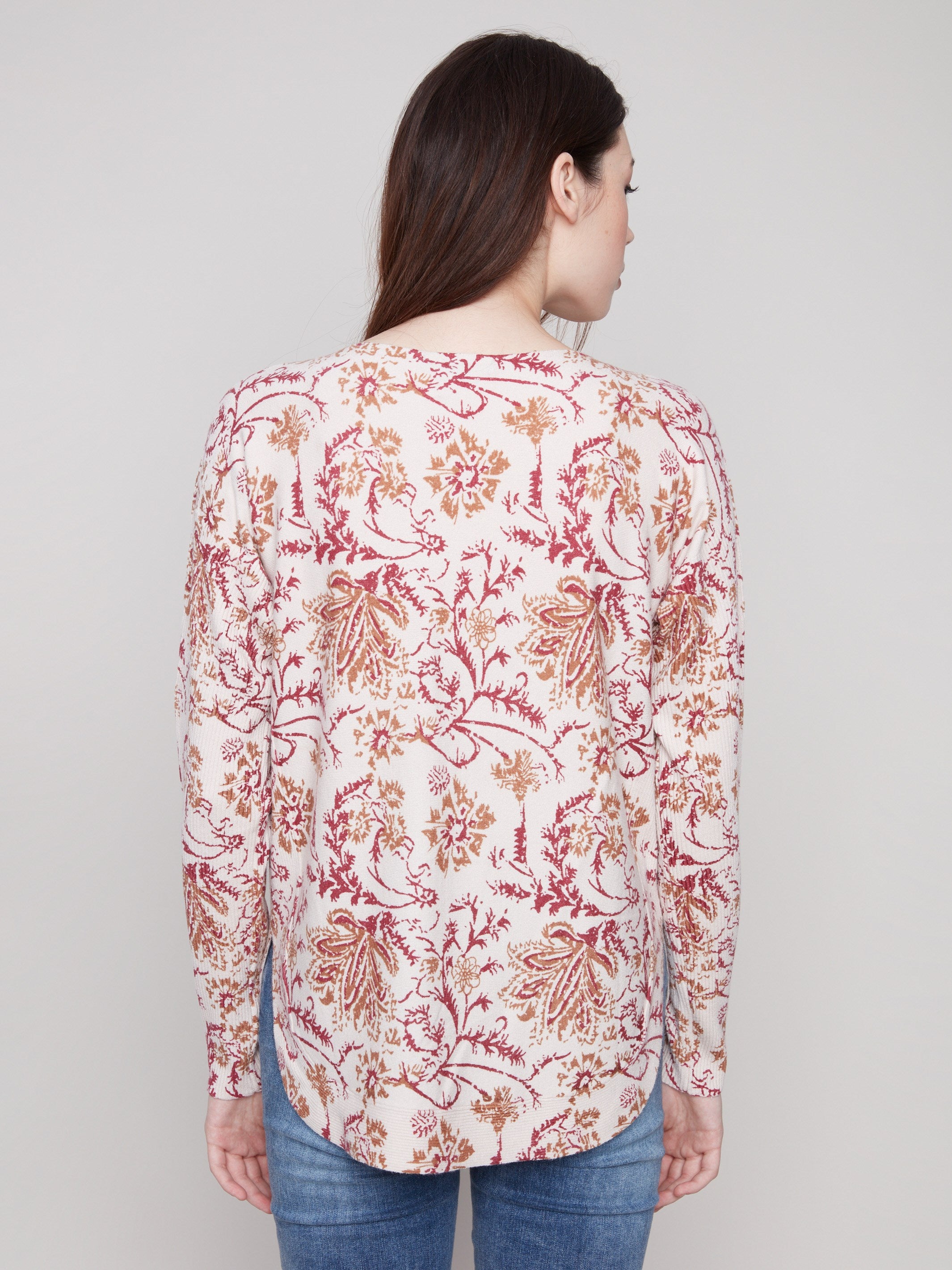 Chic calico sweater showcasing side slits for added flair and movement, ideal for any wardrobe by Charlie B.