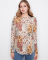 The sweater showcases a lovely boat neckline with a floral patchwork design, adding charm to any outfit by Charlie B.