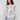 Sweater with a boat neck and abstract floral design, featuring ribbed sleeves for added texture by Charlie B.