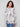 Elegant sweater showcasing ribbed sleeves and an artistic floral pattern in soft hues by Charlie B.