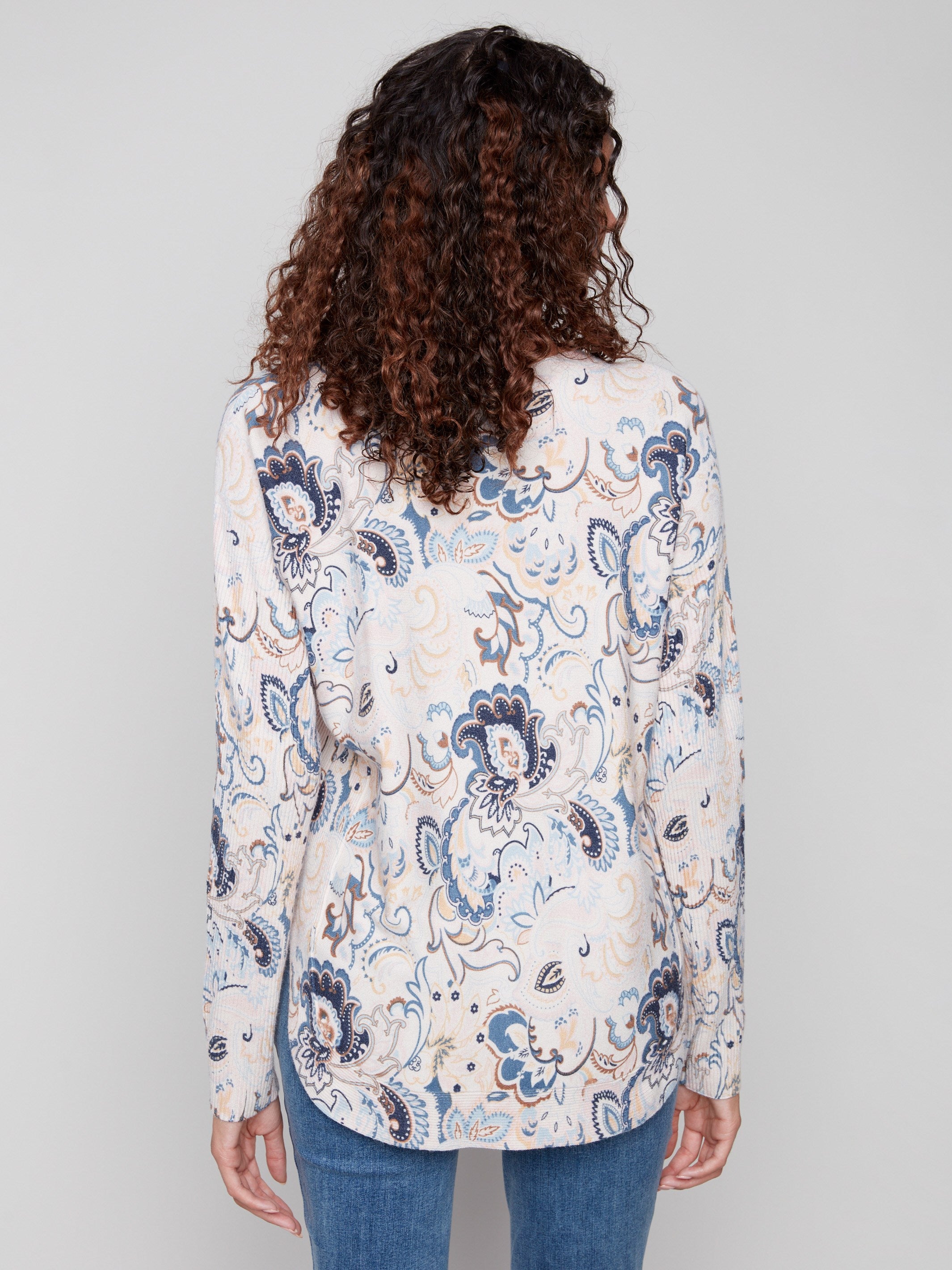 Chic sweater adorned with an abstract floral print, complete with convenient side pockets by Charlie B.