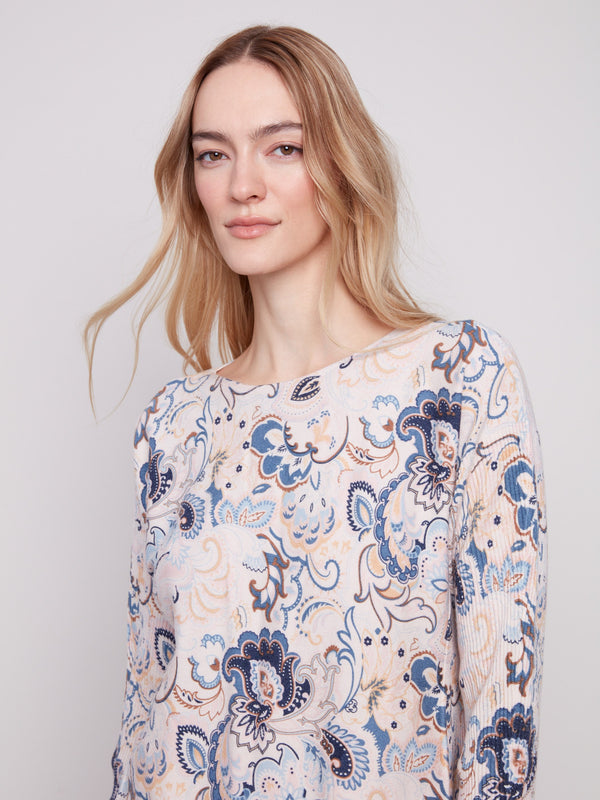 Stylish blush sweater featuring a boat neck and intricate floral motifs, adding flair to any outfit by Charlie B.