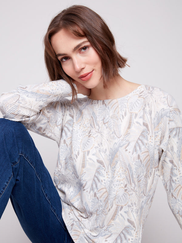 Sophisticated sweater featuring rounded hem and intricate leaf patterns, perfect for any wardrobe by Charlie B.