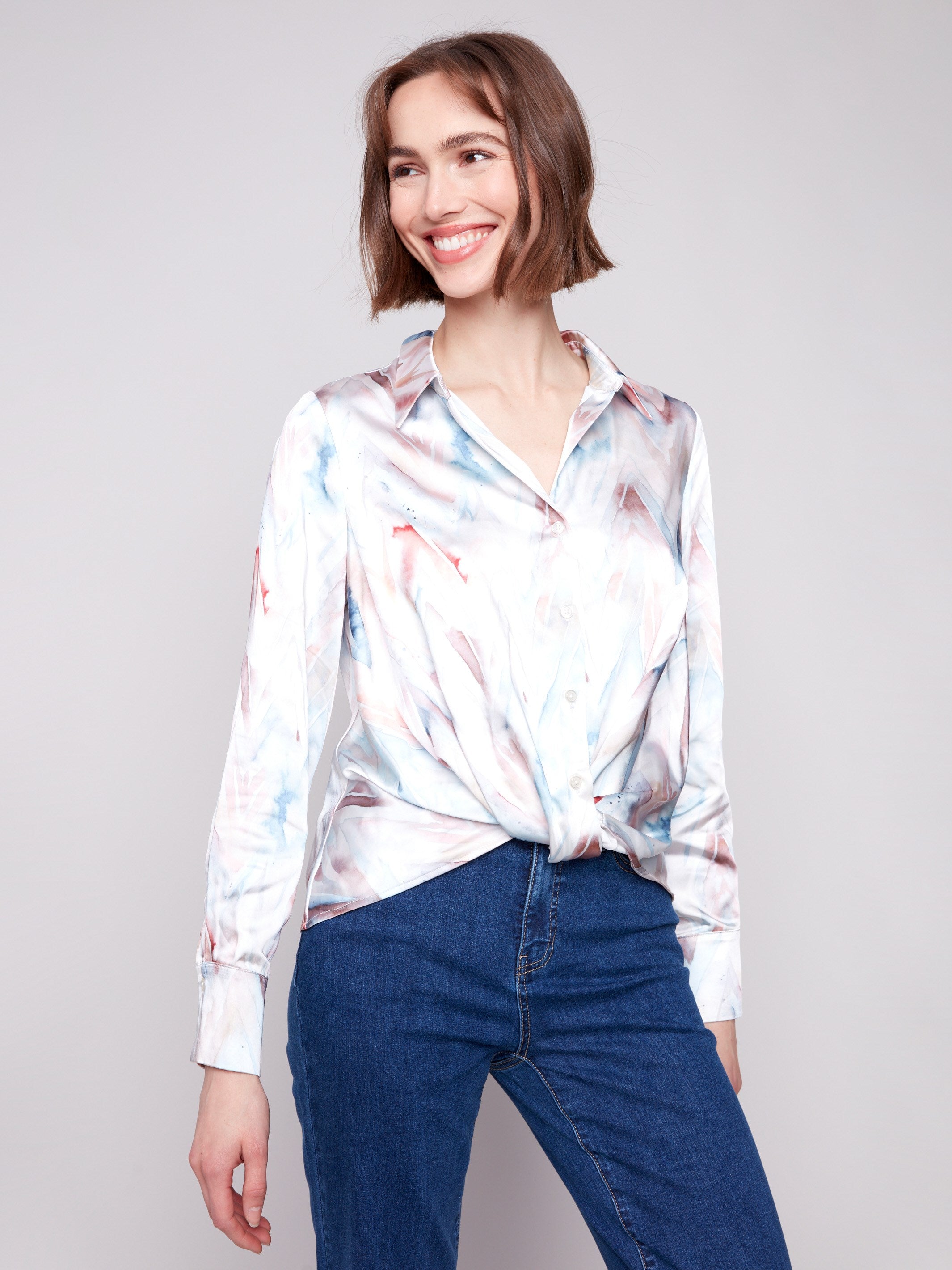 Satin shirt featuring soft satin fabric with a chevron print and a unique twisted front detail by Charlie B.