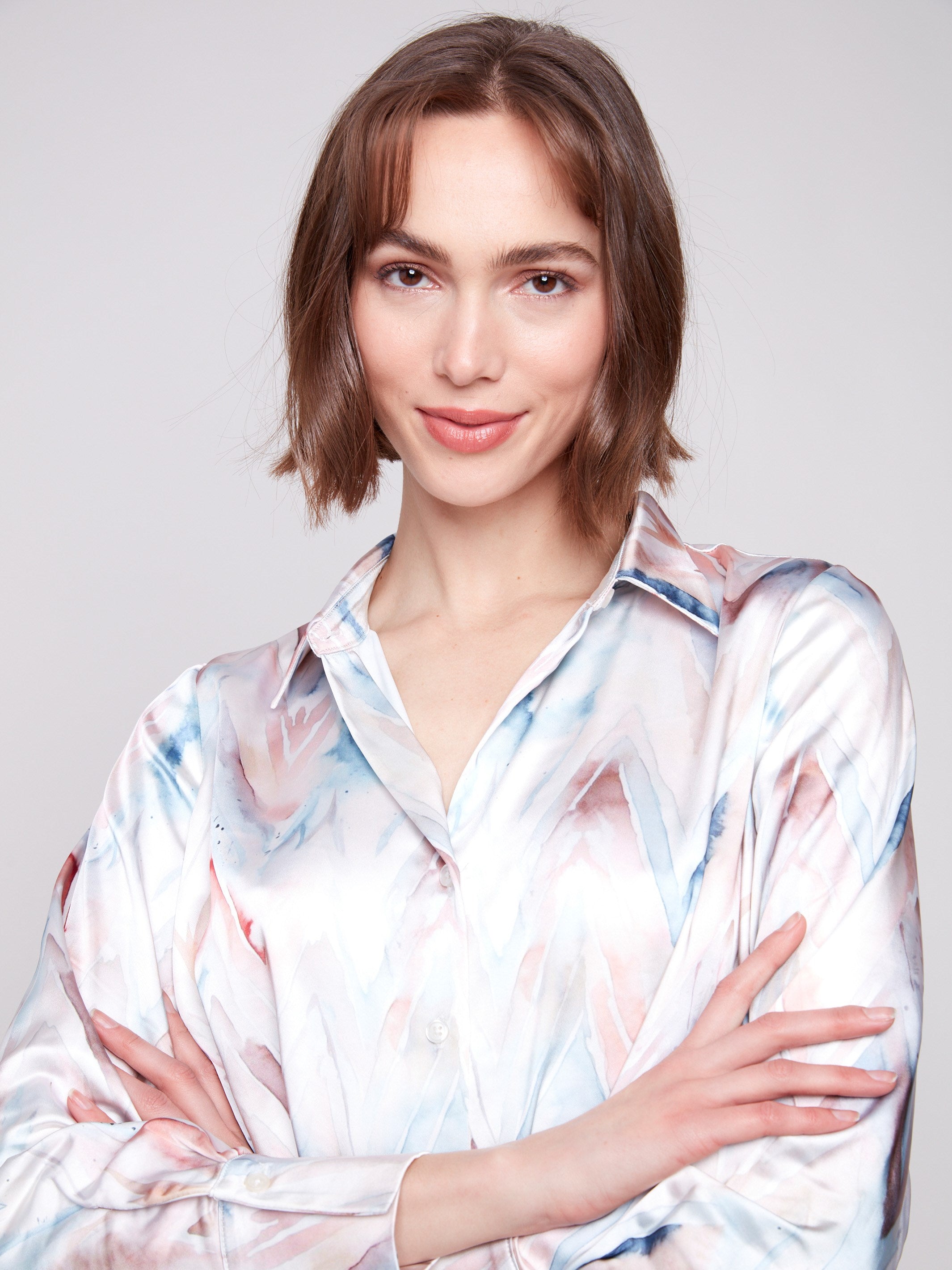 Long sleeve satin shirt showcasing a chic chevron print and classic button-down closure by Charlie B.