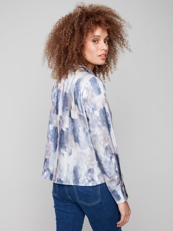 Stylish long sleeves add sophistication to this abstract patterned satin shirt with a twist by Charlie B.