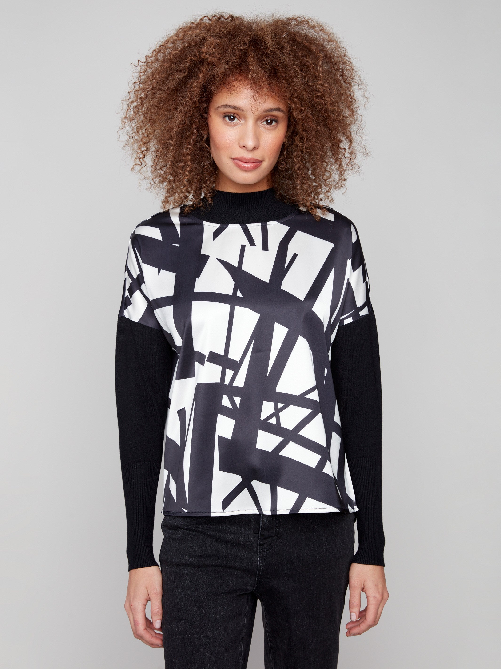 Black and cream abstract patterned top with front seam detail, featuring long sleeves by Charlie B.