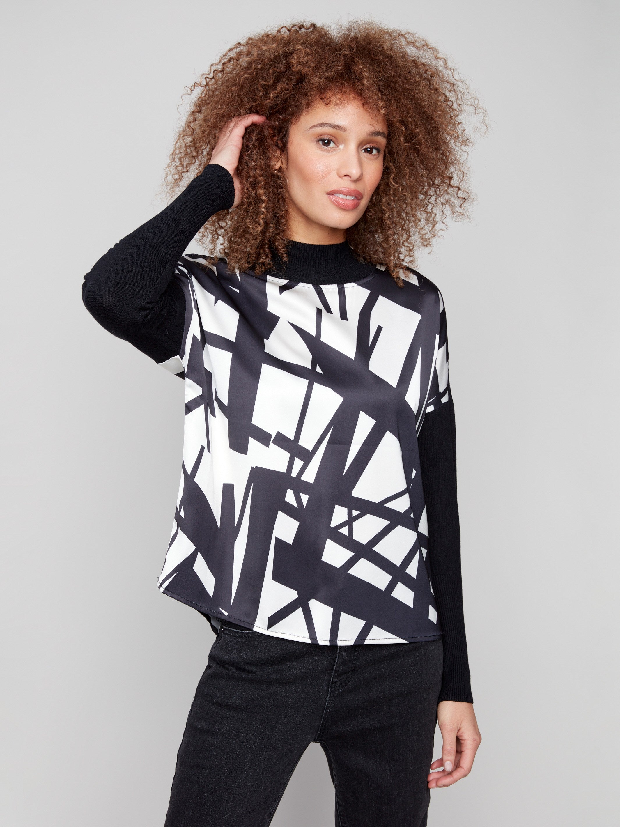 Stylish satin-knit combo top with a black and cream abstract pattern, featuring long sleeves by Charlie B.
