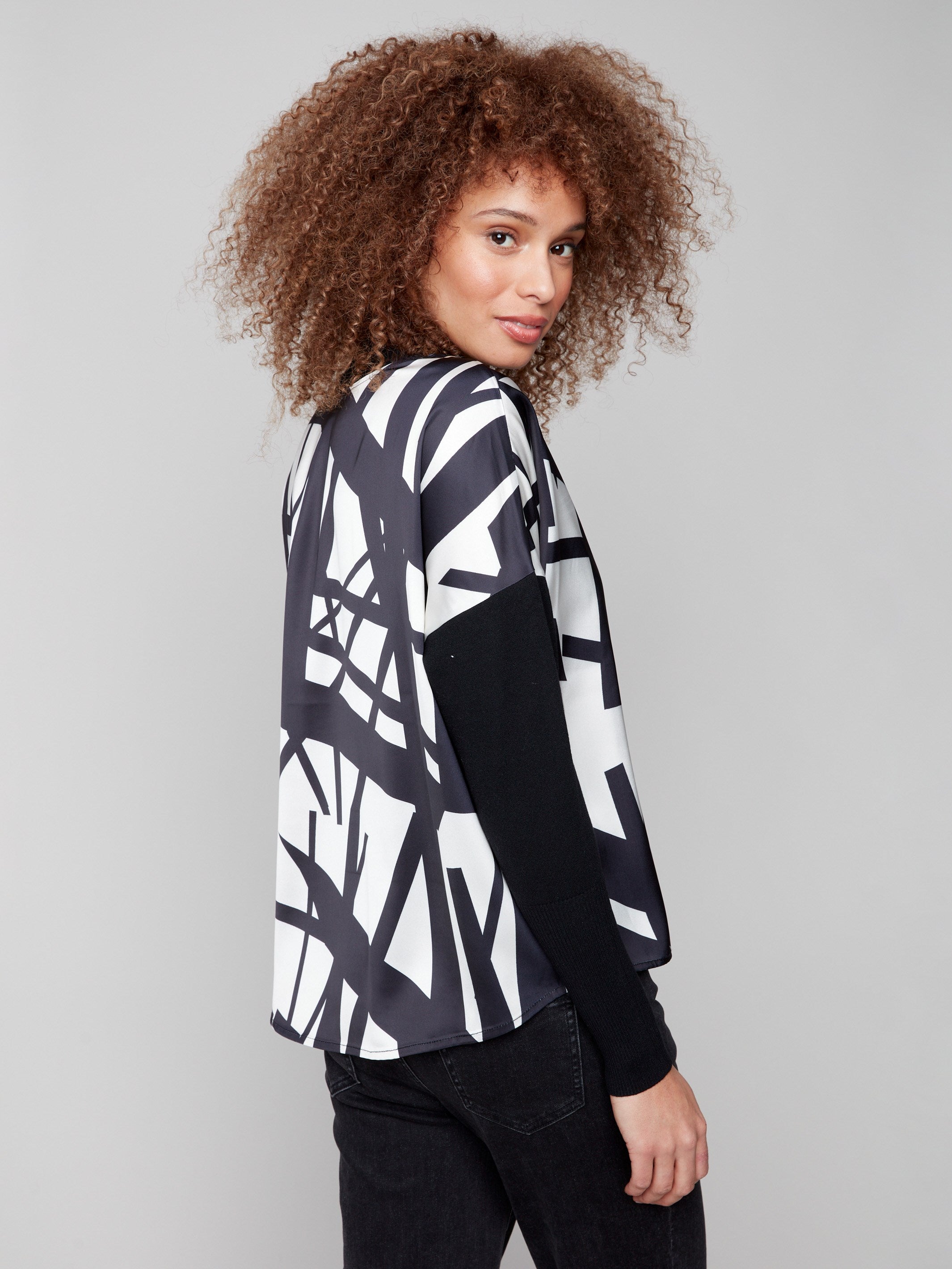 Elegant drop shoulders on this black and cream abstract patterned top, complete with long sleeves by Charlie B.